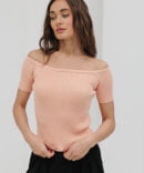 Women's light peach knitted top with open shoulders.