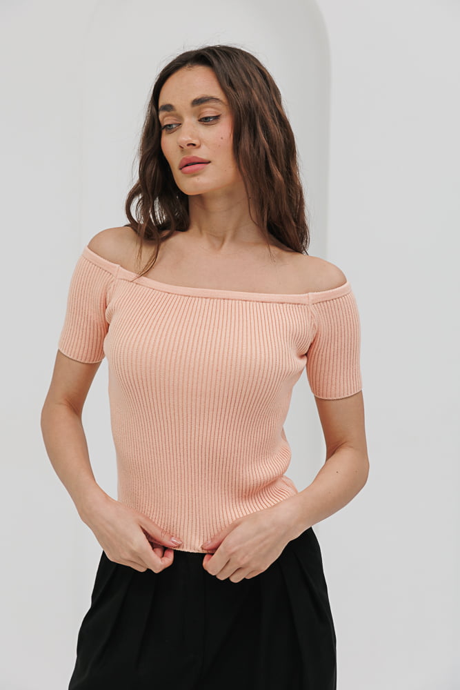 Women's light peach knitted top with open shoulders.