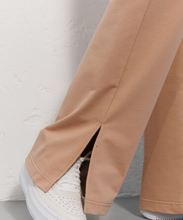 Women's straight light beige sports trousers with slits at the bottom