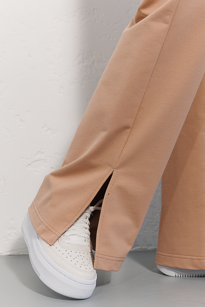 Women's straight light beige sports trousers with slits at the bottom