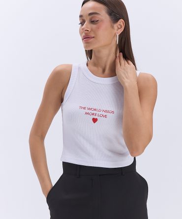 Укорочена жіноча майка в рубчик біла з написом The world needs more love