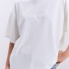 Жіноча футболка oversize молочна з вишитим написом Nude