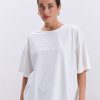 Жіноча футболка oversize молочна з вишитим написом Nude